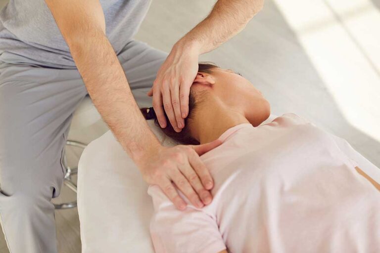 Person supporting a smartphone with both hands while gently resting a sore thumb and wrist